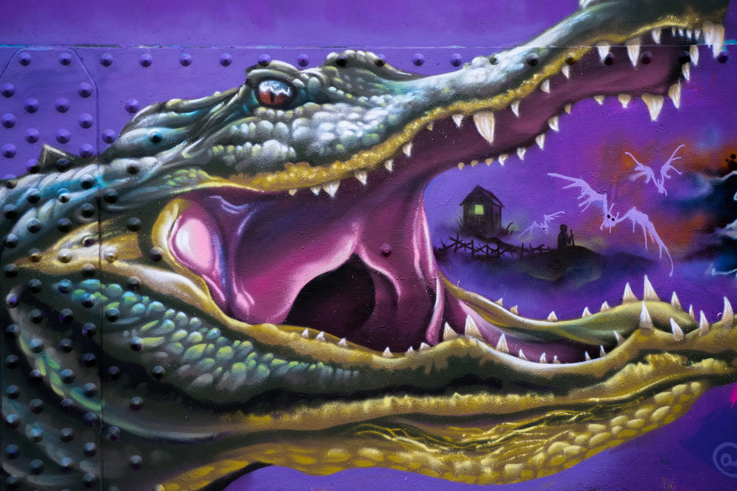 Close-up of a vivid purple and green alligator mural