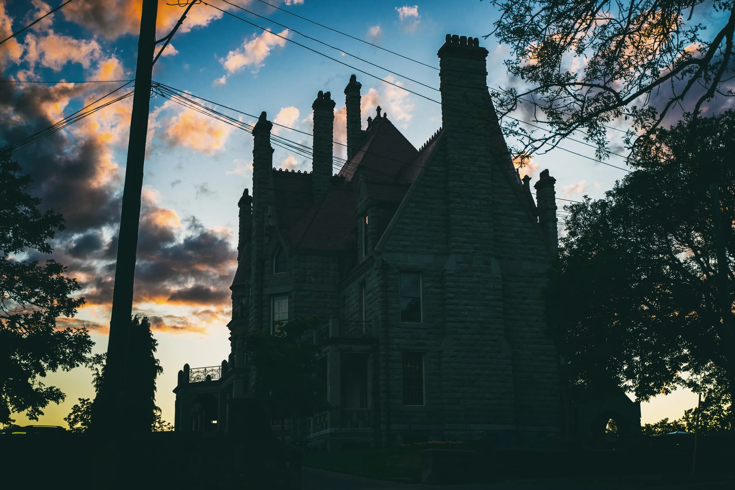 Gothic castle turrets silhouetted against a sunset sky in Victoria, British Columbia