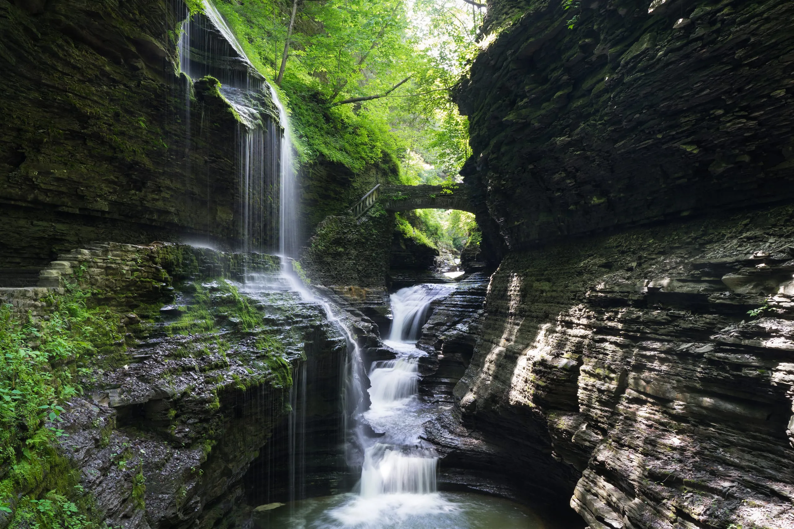Rainbow Falls streaming over mossy layered shale in Watkins Glen State Park