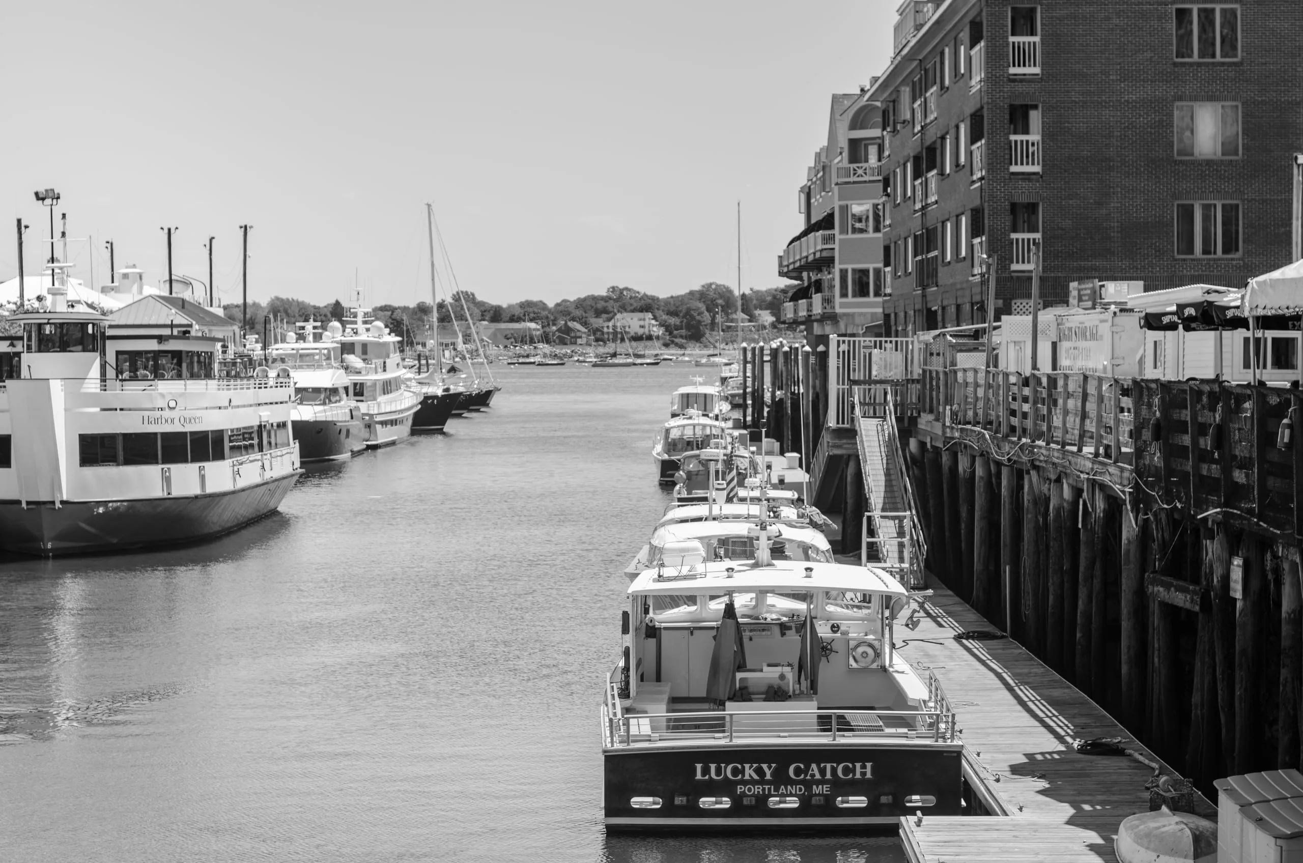 Black and white view of a working fishing wharf in Portland, Maine