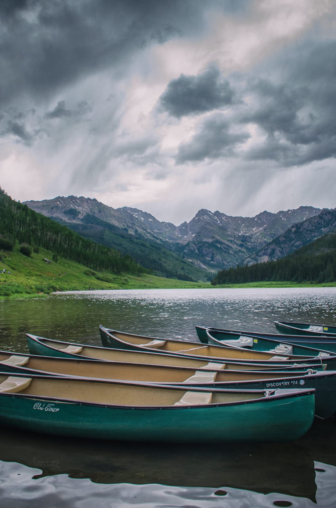 Canoes on Piney Lake under approaching storm light in Colorado